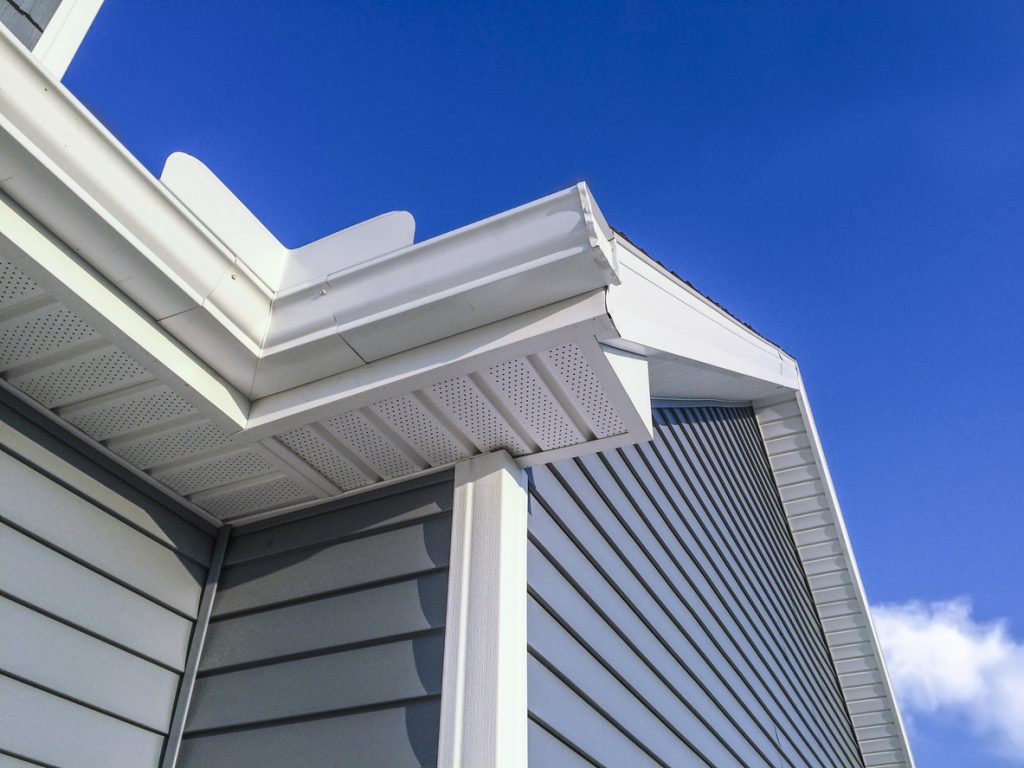 Blue grey vinyl siding close-up on a home.