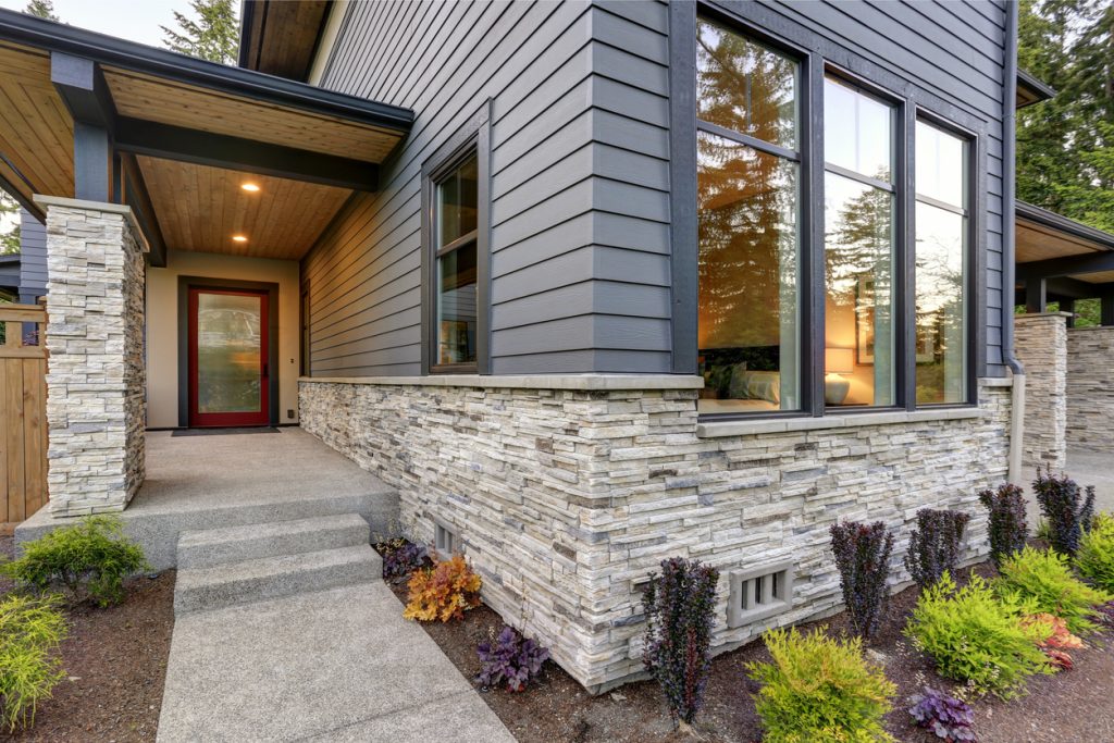 Modern home with a blend of stone and vinyl siding.